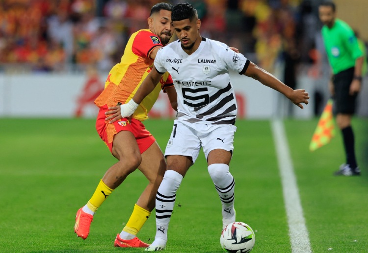 Facundo Medina battles for the ball with Ludovic Blas during their Ligue 1